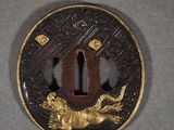 a picture of a gold and black tsubai with a lion on it