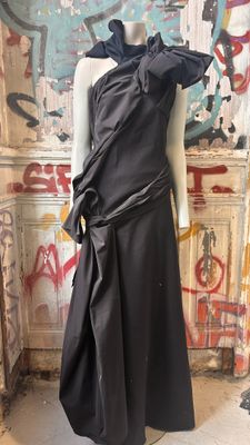 the mannequin is standing in front of a wall with graffiti on it