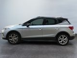 the silver car is parked in a large room with a white wall