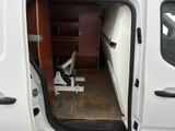 a white van with a door open and a chair in the back