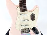 a pink guitar that is sitting on top of a stand