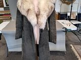 an image of a coat on a mannequin stand in a room