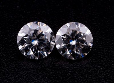 une paire de diamants taille ronde sur un fond noir