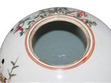 a white vase with a floral design on it