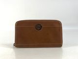 a brown leather wallet with a circular logo on the front