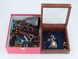an open box with a bunch of jewelry inside of it