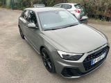 the audi rs3 is parked in a parking lot with other cars in the background