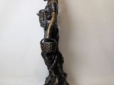 statue of a woman with a basket of flowers in her hands