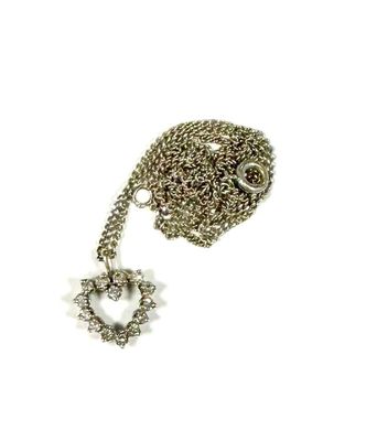 necklace with a heart and a star on a chain on a white background
