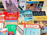 several books are stacked on top of each other on a table