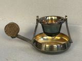 a small metal object with a wooden handle on a table