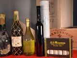 several bottles of wine are lined up on a red table