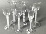 six wine glasses sitting next to each other on a table