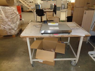 a table that has a laptop on it in a room