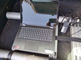 a laptop computer that is sitting on the floor of a car