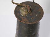 an old fashioned brass and black oil canister with a handle