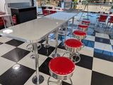 a checkered floor in a diner with red stools