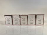 four boxes of soap sitting on top of a white table
