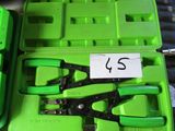 a lot of tools in a green case on a table