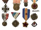many medals and medals on display on a white background
