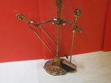 a metal sculpture of a man with a sword and a hat on a stand