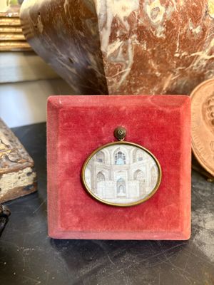 a close up of a red box with a picture of a building on it
