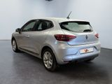 the rear end of a silver car in a white room