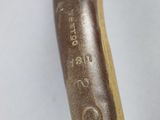 a close up of a hammer with a wooden handle on a white surface