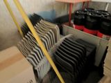 a lot of chairs that are stacked up in a room