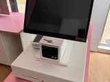 a pink desk with a computer on top of it