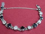 silver bracelet with black and white stones and silver chain