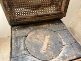 a wooden chair with a seat that has a hole in the back