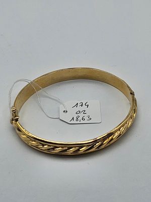 a close up of a gold bracelet with a price tag on it