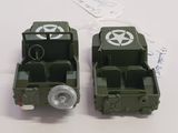 two toy army vehicles sitting next to each other on a table