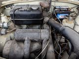 an old car engine with a lot of rust on it