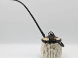 an image of a white vase with a black handle and a black handle