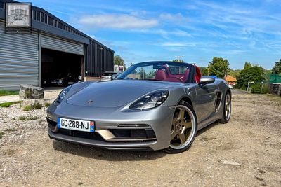 a silver sports car parked in front of a building