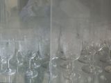 many wine glasses lined up in a row on the counter