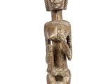an image of a wooden statue of a woman holding a baby