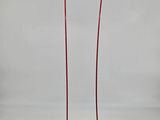 a black and red lamp on a stand with a black base