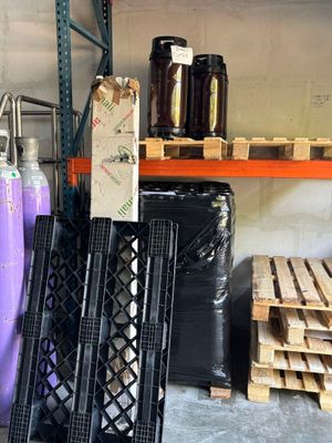 a large amount of bottles and pallets in a warehouse