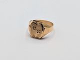 a close up of a gold signet ring with a man ' s face on it