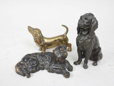 three bronze figurines of dogs sitting next to each other