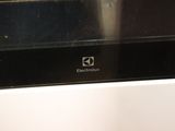 someone is cleaning the oven with a sponge and a rag