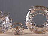 three glass vases sitting on a table next to each other