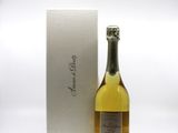 bottle of champagne in front of a white box with a silver lid