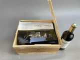 a bottle of wine and a book in a wooden box
