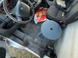 a person standing in the driver ' s seat of a truck
