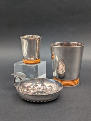 two cups and a bowl sitting on a table