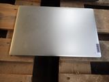 a silver laptop sitting on a pallet on a pallet